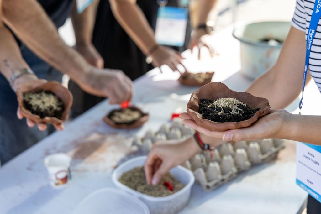 Eco-friendly volunteers working together outdoors to plant new vegetation and care for the natural environment during a corporate sustainability event.