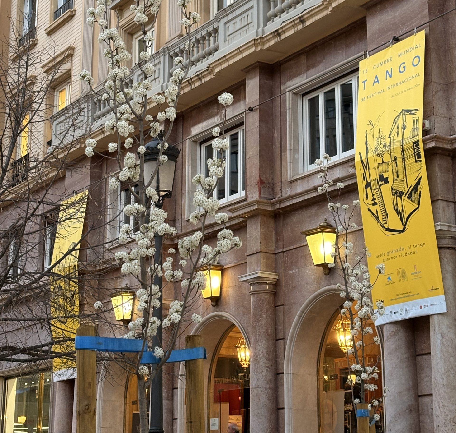 Detailed view of a historic Andalusian building balcony showcasing official event branding and banners for premium cultural tourism experiences in Spain.