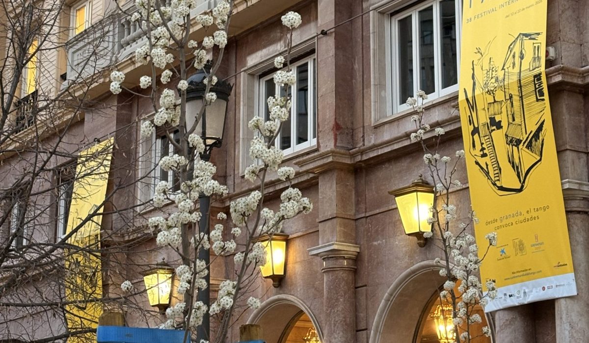 Detailed view of a historic Andalusian building balcony showcasing official event branding and banners for premium cultural tourism experiences in Spain.