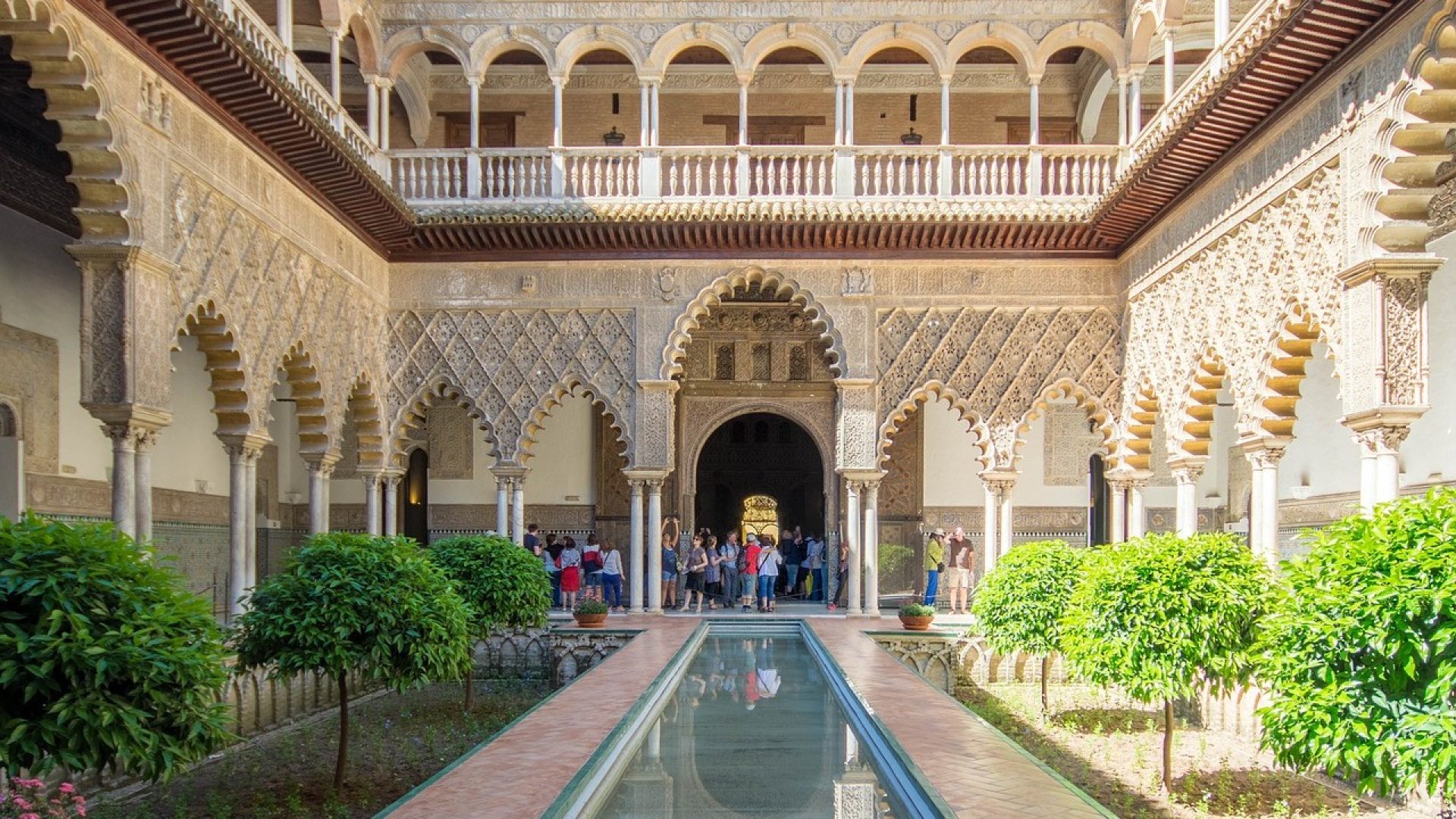 Beautiful architectural view looking through a traditional Moorish archway inside a historic palace courtyard venue in Granada Andalusia.
