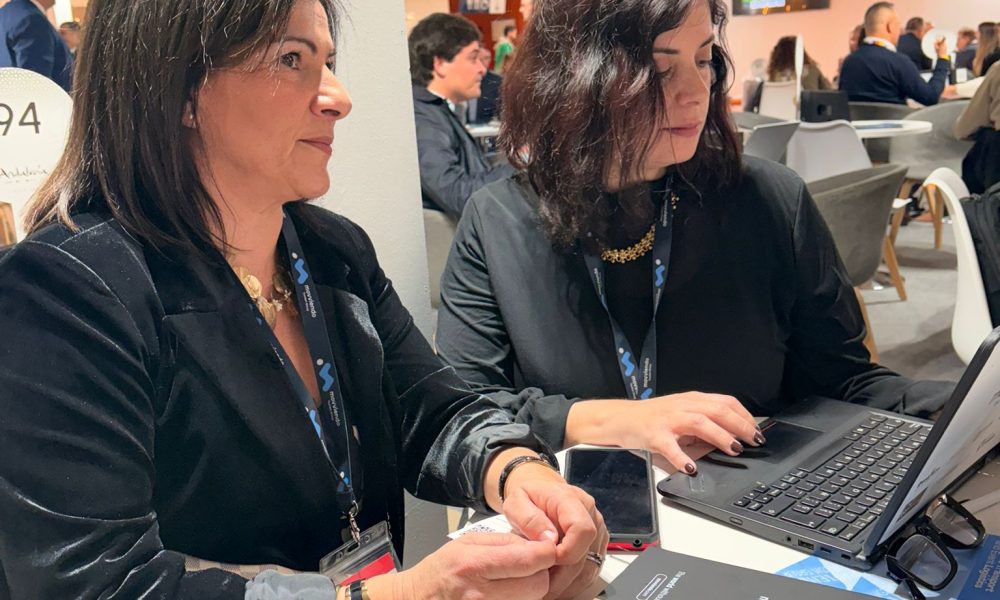 Professional female tourism executives holding a strategic B2B networking meeting at a round table during an international travel trade exhibition in Europe.